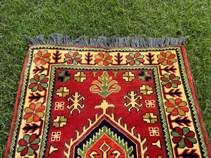 Decorative rug with intricate patterns on a grassy background